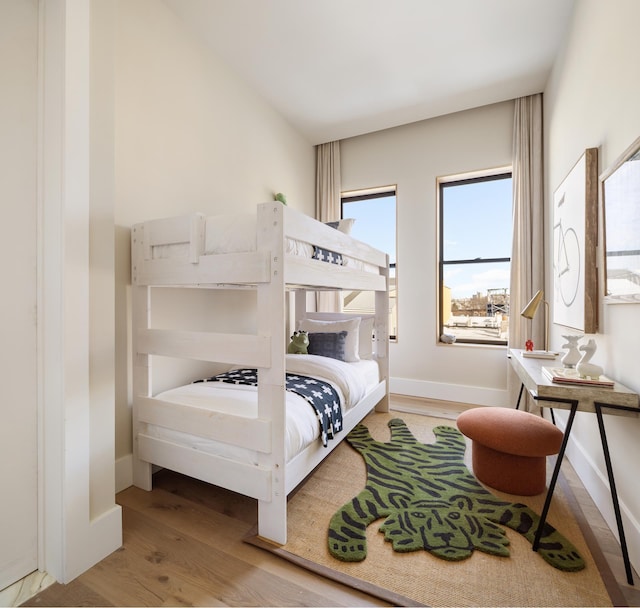 bedroom featuring baseboards and wood finished floors