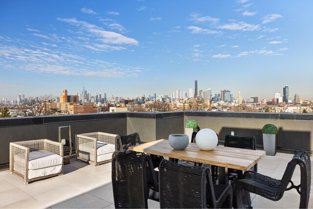 view of patio / terrace featuring a city view and a balcony