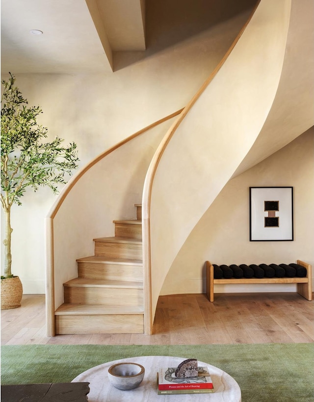 staircase with hardwood / wood-style flooring