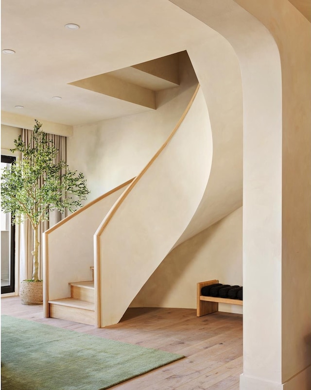 stairs with recessed lighting and hardwood / wood-style floors