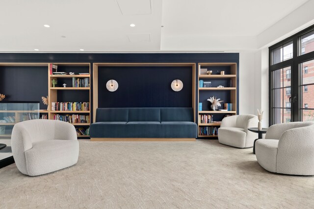 living area featuring carpet floors and built in shelves