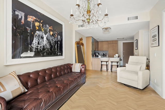 living room with baseboards, visible vents, and a chandelier