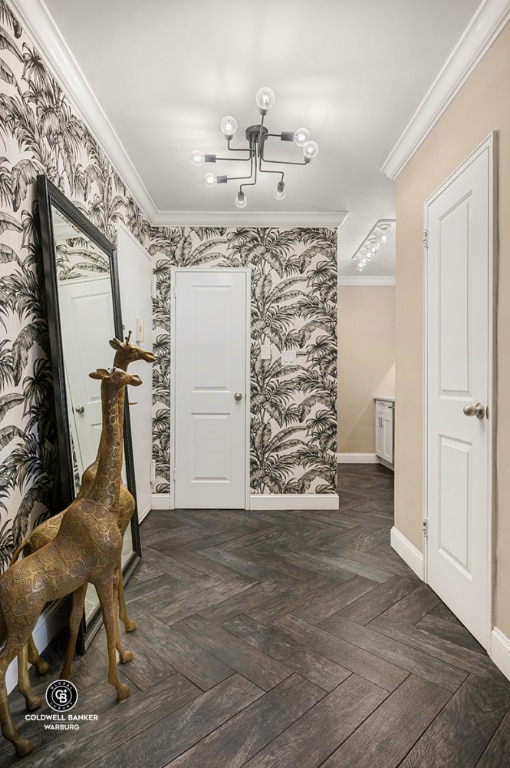 entrance foyer with ornamental molding and dark parquet floors