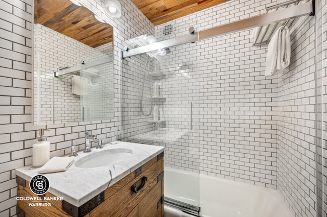 bathroom featuring wood ceiling, enclosed tub / shower combo, vanity, and tile walls