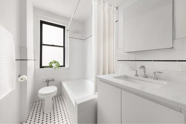 full bathroom with toilet, shower / bath combo, tile walls, tile patterned floors, and vanity