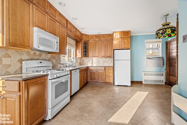 kitchen with sink, white appliances, radiator heating unit, and decorative backsplash