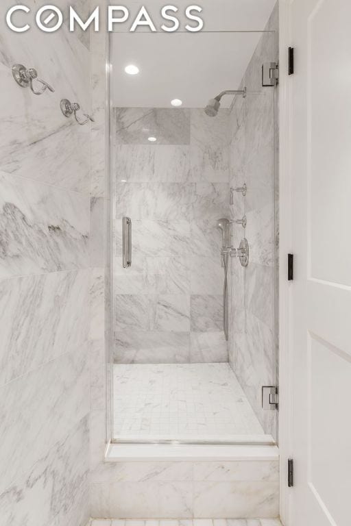 bathroom featuring a shower with shower door