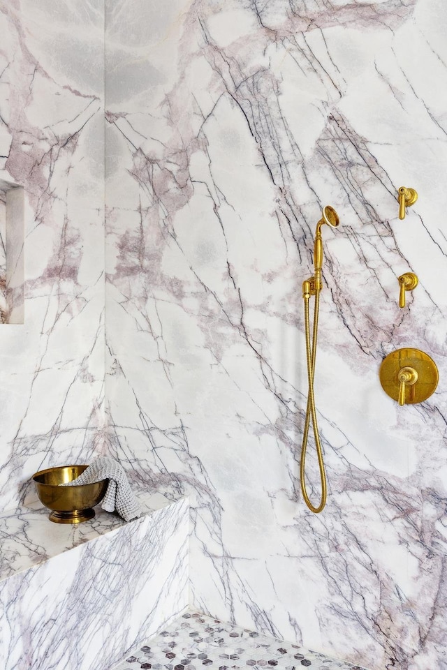 room details with a marble finish shower