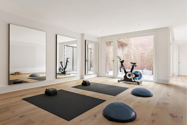 workout room with light hardwood / wood-style floors