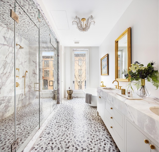 bathroom featuring a marble finish shower, double vanity, visible vents, a freestanding bath, and a sink