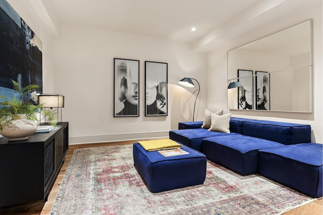 living room featuring baseboards, wood finished floors, and recessed lighting