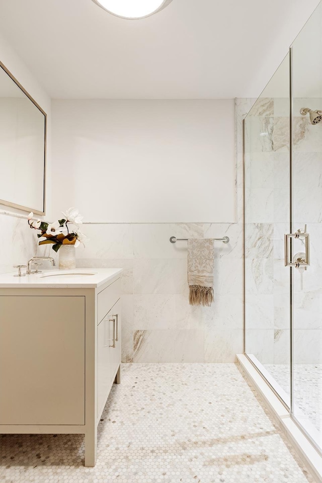 full bathroom featuring a shower stall and vanity