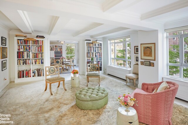 carpeted living room featuring crown molding and beam ceiling