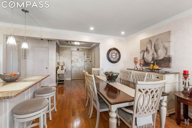 dining area featuring dark hardwood / wood-style flooring and crown molding