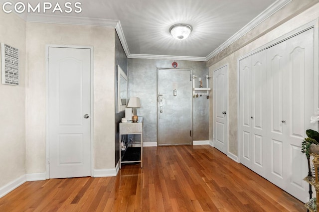 entrance foyer featuring wood-type flooring and crown molding