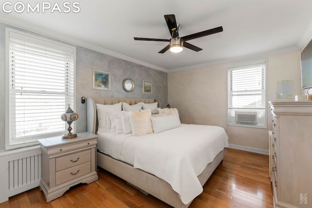 bedroom with radiator heating unit, cooling unit, light hardwood / wood-style floors, ornamental molding, and ceiling fan