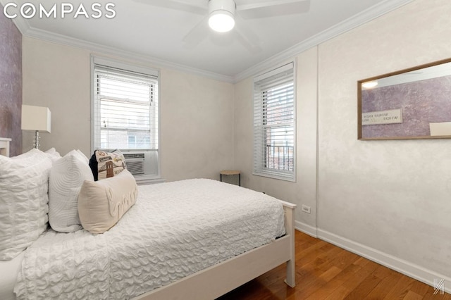 bedroom featuring ceiling fan, hardwood / wood-style flooring, and ornamental molding