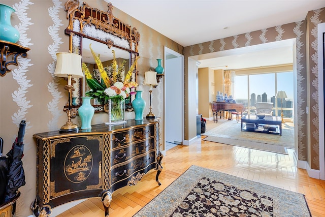 corridor featuring a view of city and baseboards