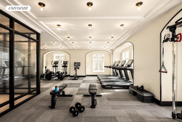 exercise room with arched walkways, carpet flooring, and visible vents