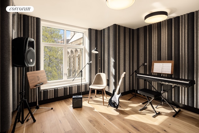 misc room featuring visible vents, light wood-type flooring, and wallpapered walls