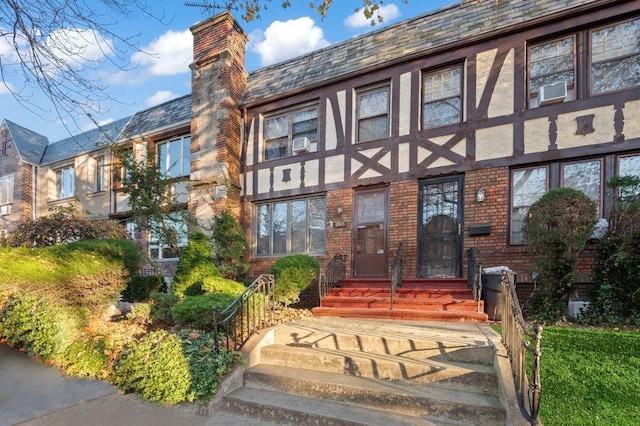 exterior space with brick siding and a chimney