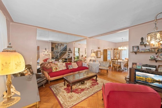 living area featuring stairs and a notable chandelier