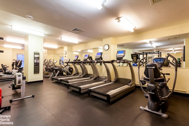 gym featuring baseboards and visible vents