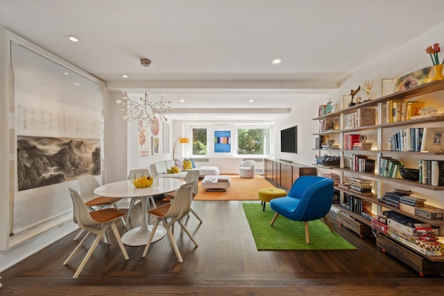 dining area with dark hardwood / wood-style floors and a notable chandelier