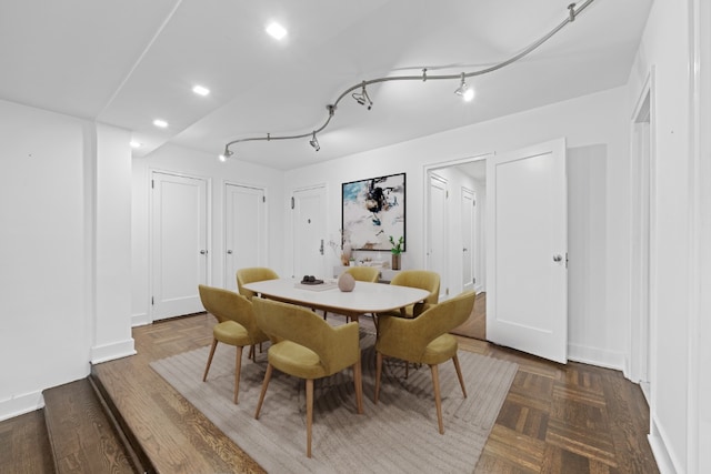 bedroom with ceiling fan, dark hardwood / wood-style floors, and wooden walls