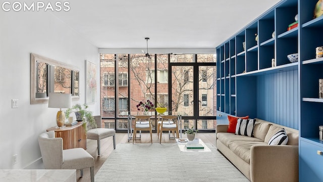 sitting room featuring hardwood / wood-style floors and expansive windows