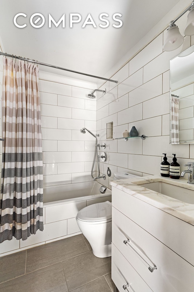 full bathroom featuring toilet, shower / tub combo, tile walls, vanity, and tile patterned floors