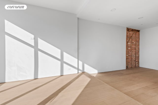 spare room featuring wood finished floors and visible vents