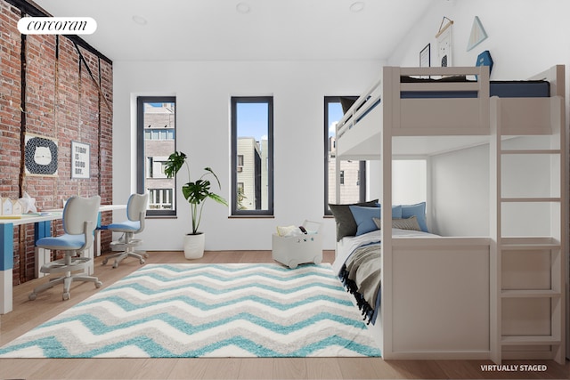 bedroom featuring brick wall