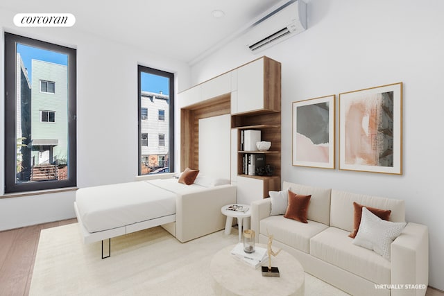 living area featuring a wall mounted air conditioner, visible vents, and light wood finished floors