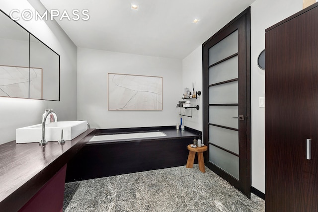 bathroom featuring a bath and vanity