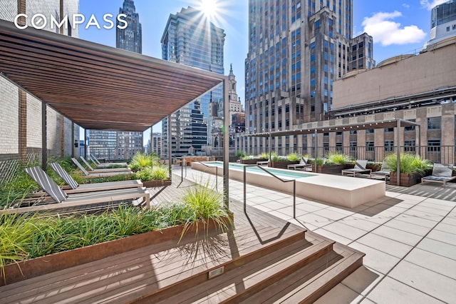 view of property's community featuring a patio, a view of city, and a swimming pool