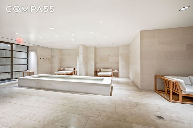 full bath featuring tile patterned flooring, a relaxing tiled tub, and recessed lighting