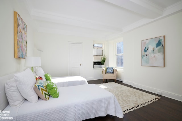 bedroom featuring hardwood / wood-style floors and beam ceiling