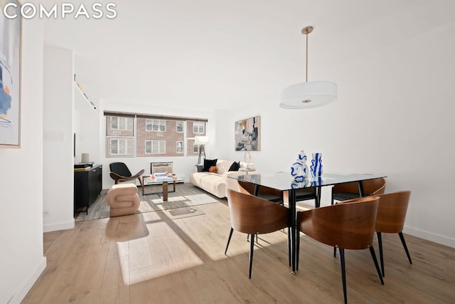 dining space with hardwood / wood-style flooring