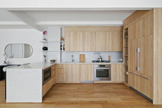 kitchen with stainless steel appliances, light hardwood / wood-style floors, sink, and light brown cabinets