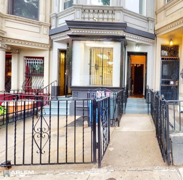 view of exterior entry featuring a gate and fence