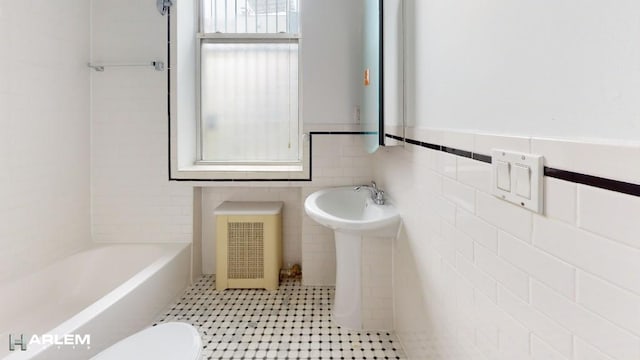 full bathroom featuring a tub to relax in, a shower, toilet, radiator heating unit, and tile walls