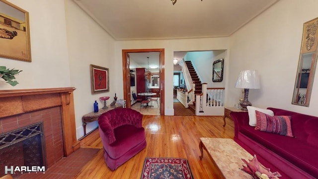 living room featuring hardwood / wood-style floors and a tile fireplace