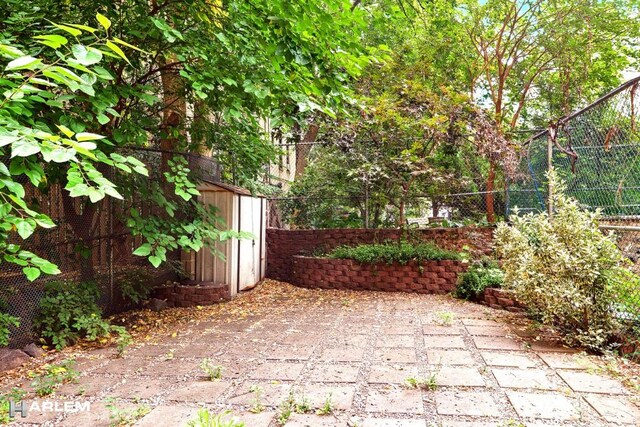 view of patio with a storage shed