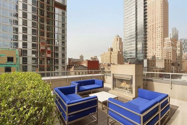 exterior space with an outdoor living space with a fireplace