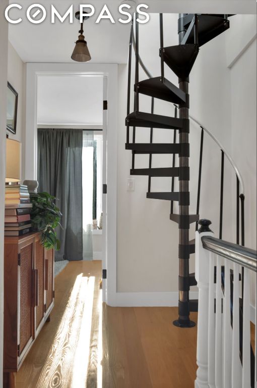 stairway with hardwood / wood-style flooring