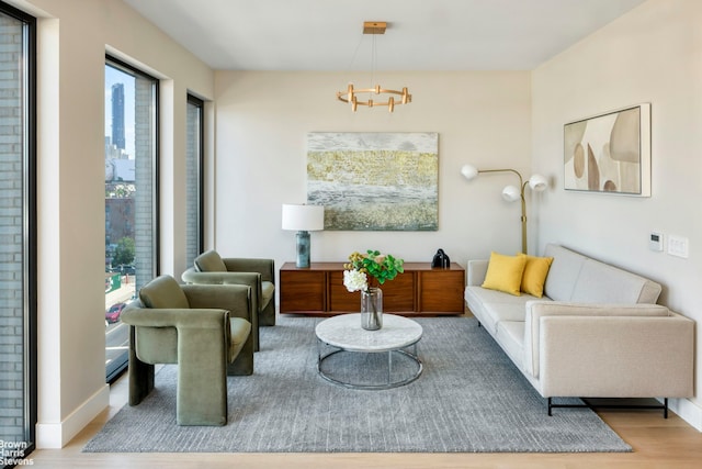 sitting room featuring wood finished floors and a chandelier