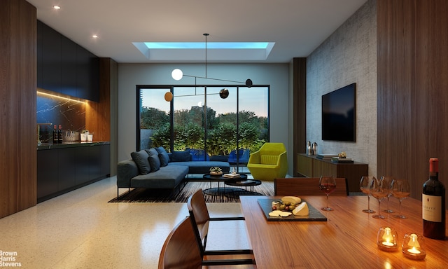 dining room featuring a skylight and speckled floor