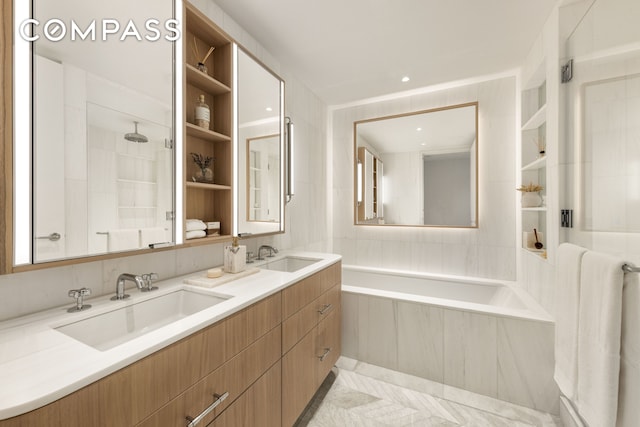 bathroom featuring a tub to relax in, walk in shower, double vanity, and a sink