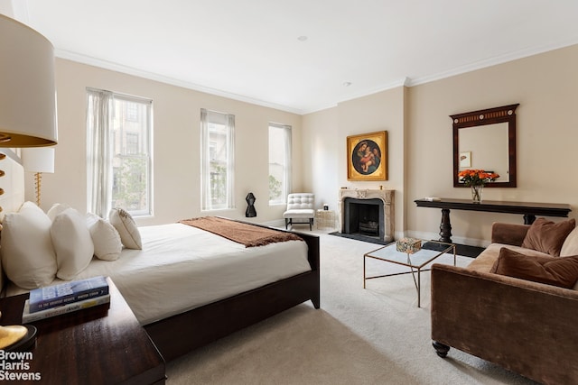 carpeted bedroom with a high end fireplace, baseboards, and ornamental molding